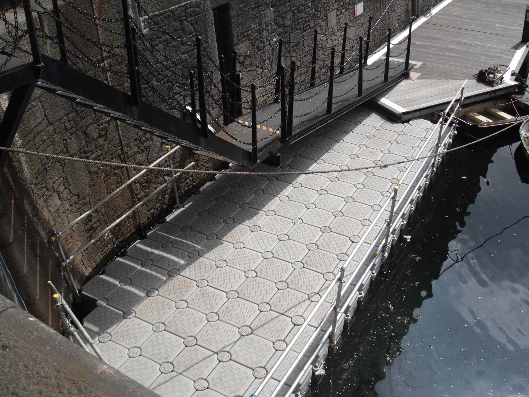 Floating pontoon providing waterside maintenance access at Albert Dock in Liverpool