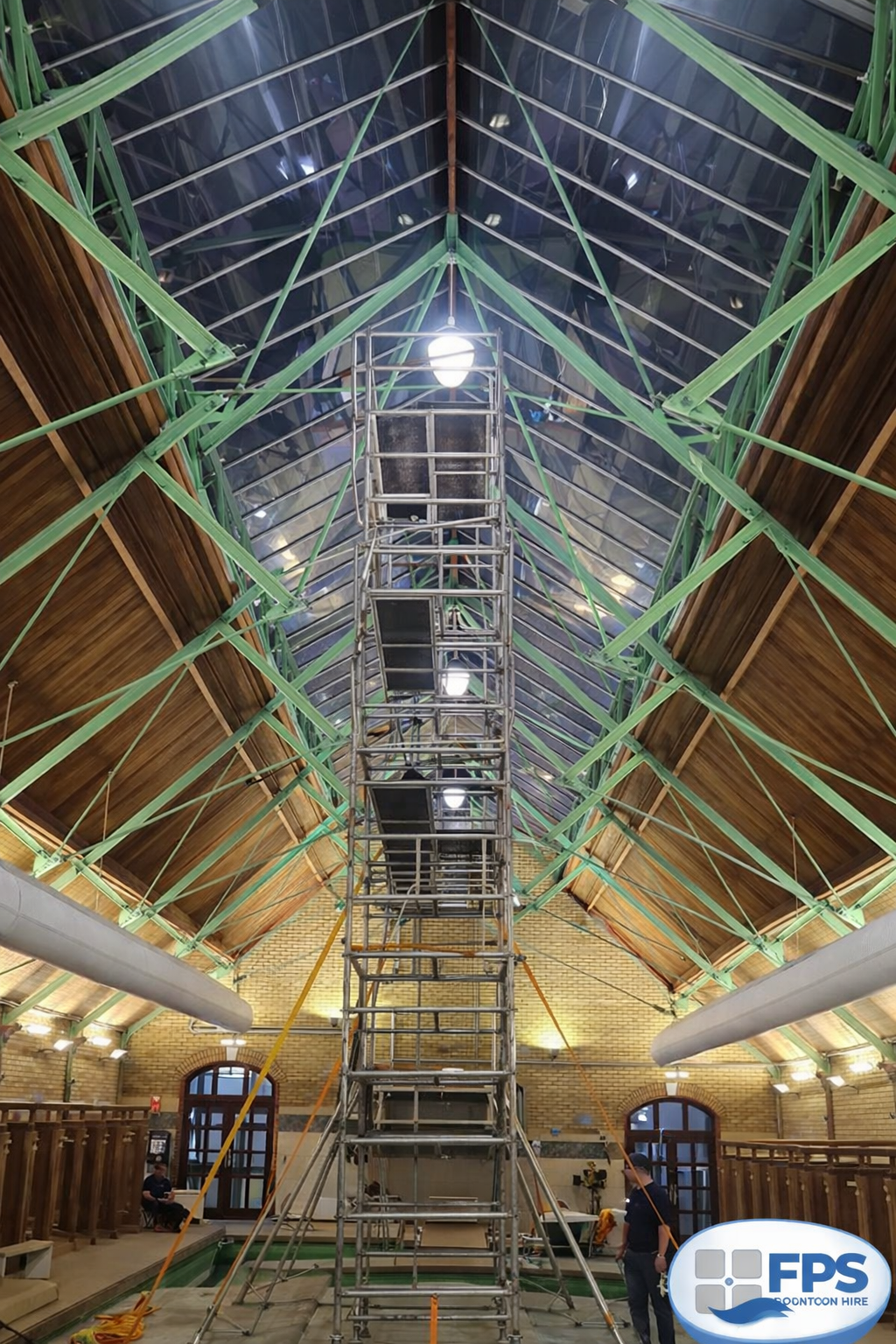 Floating pontoon and scaffold tower providing high-level access for swimming pool maintenance